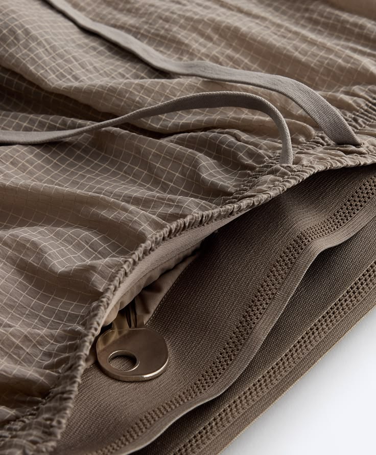 Shelf of folded shorts sorted by length