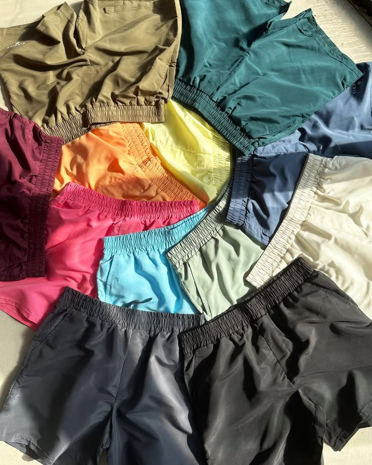 Folded shorts and base layers on the stock bench in daylight